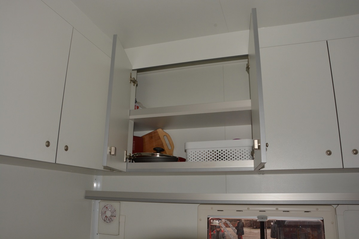 По всему периметру кухни развешаны шкафчики для различной утвари