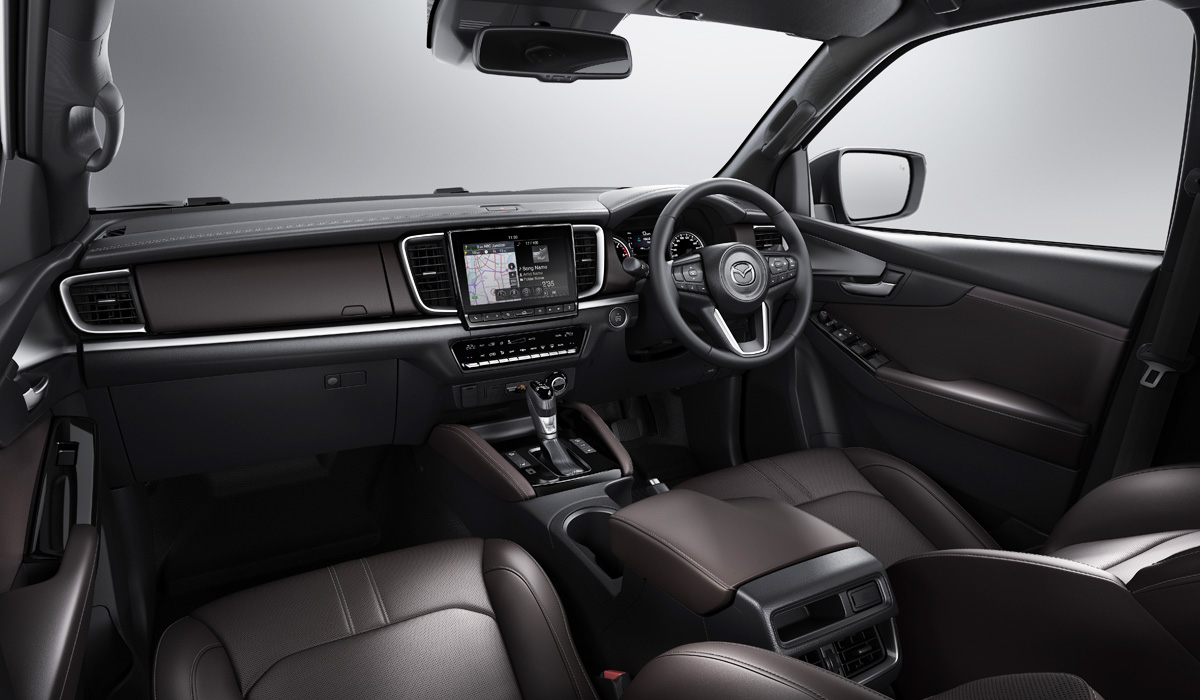Mazda's stylists also did a good job on the interior. The location of key elements such as ventilation deflectors, media system screen, or climate control unit is the same as that of Isuzu, but the design is still different